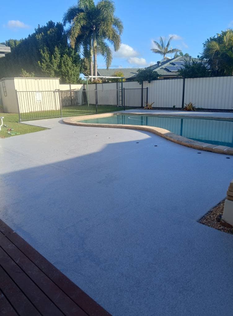 Light grey epoxy coating around backyard pool area